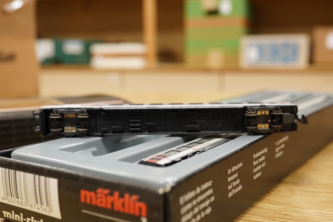 A Marklin Z gauge railway collection, Swiss railway from set 81852, including an SBB CFF FFS Bo-Bo pantograph electric locomotive, together with a boxed Mini-club unpowered 4-car set (87456), three freight wagons, a brid